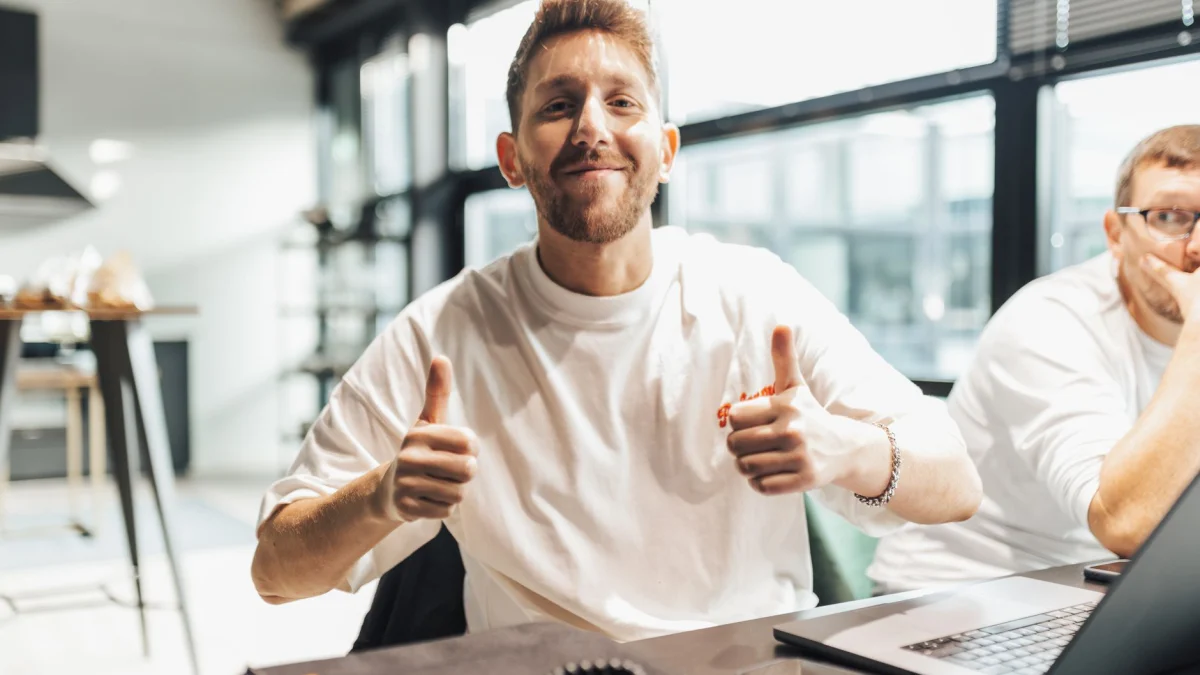 Jonge professionals in een moderne kantooromgeving die deelnemen aan een positieve discussie.