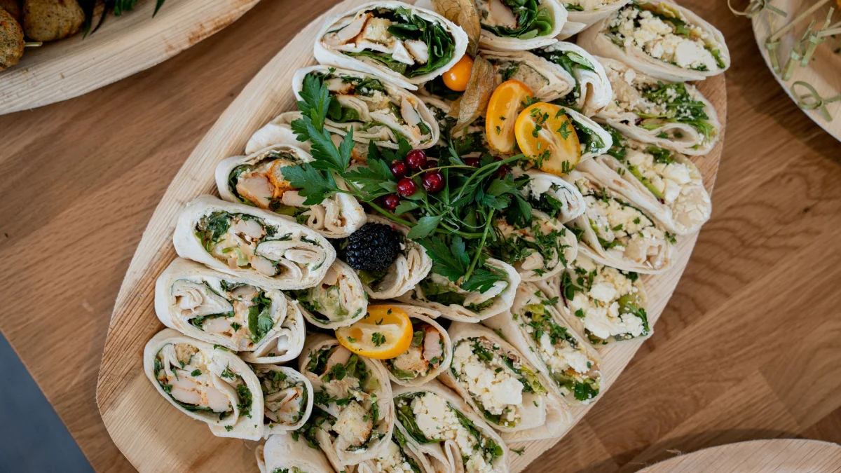 Heerlijke gourmet wraps op een houten plank, perfect voor feesten en vieringen.